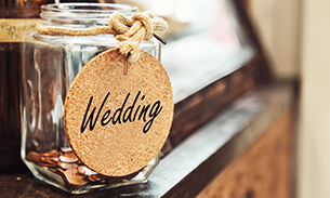 Jar filled with pennies with a sign called wedding